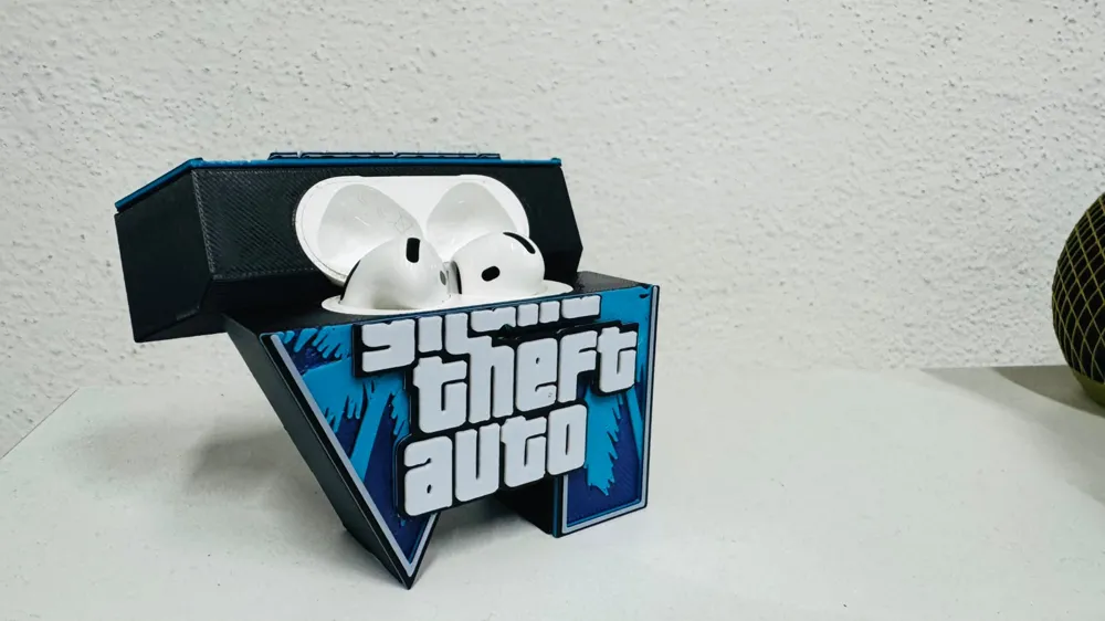 AirPods case sitting in a blue GTA logo stand