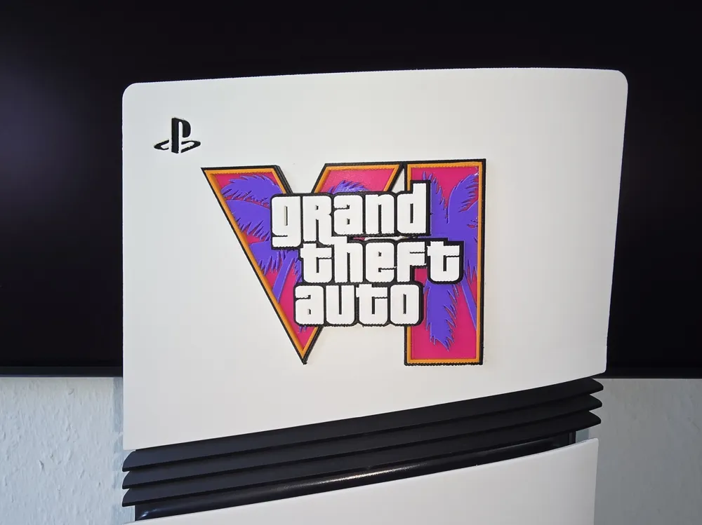 Raised GTA VI logo badge fitted to the side of a white PS5