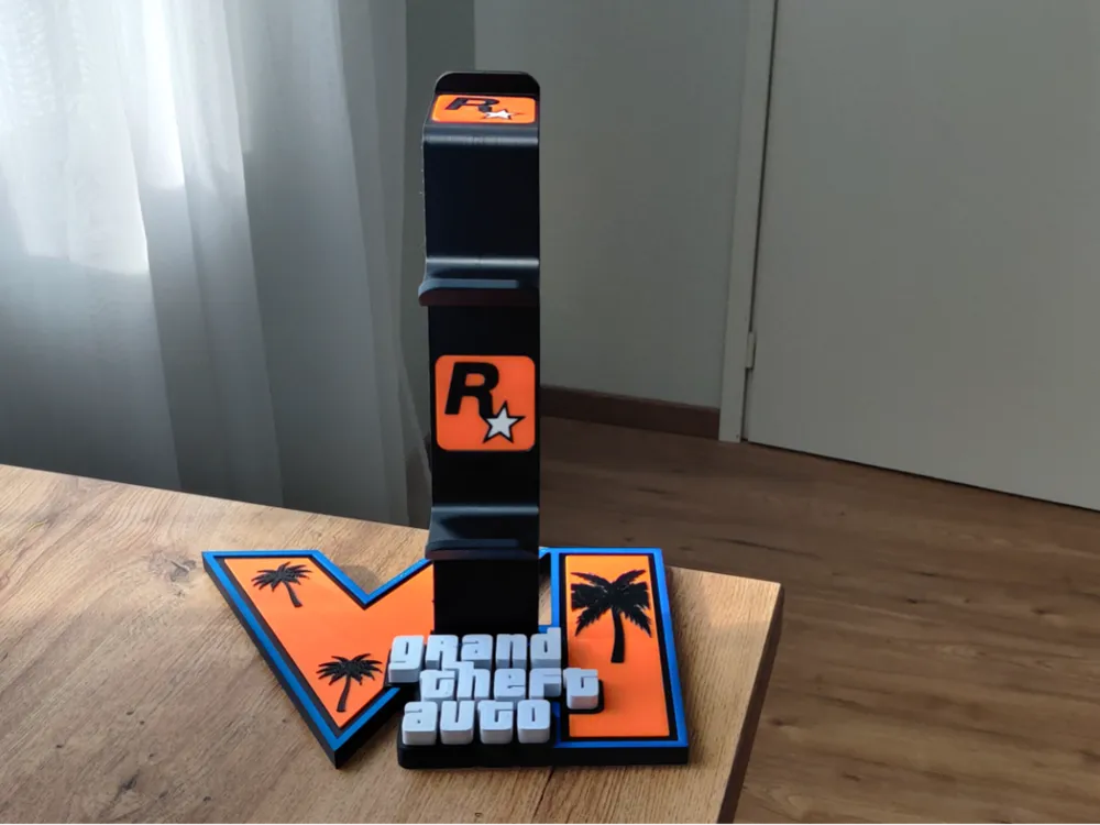 Black universal stand with a Rockstar logo on an orange GTA VI logo base